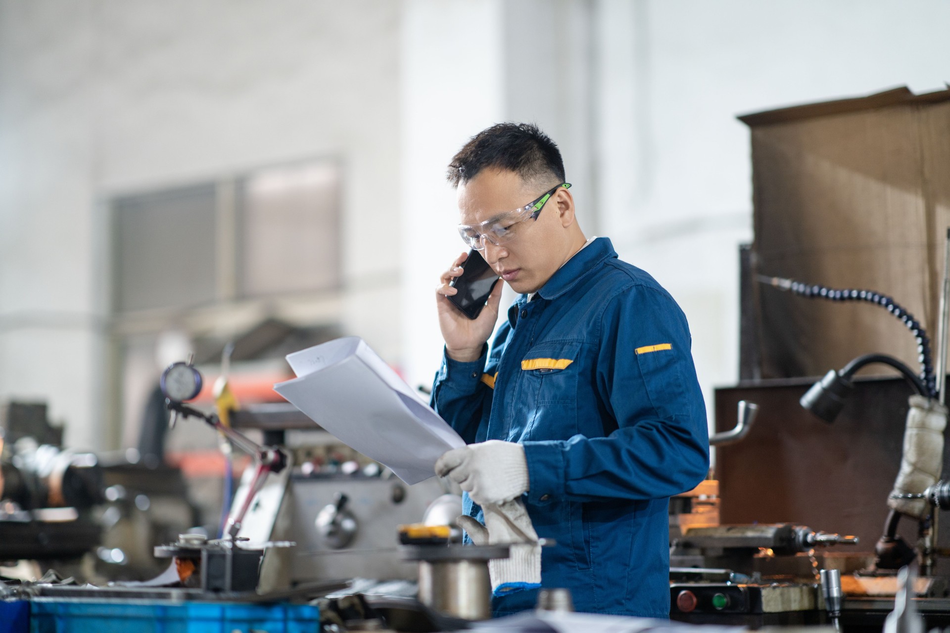 asian male engineer working on lathe